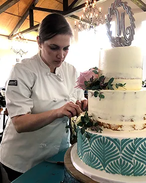 Ashley decorating a wedding cake