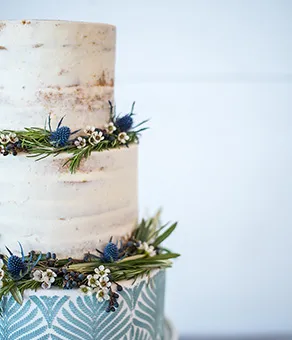 Three tier semi-naked stenciled wedding cake
