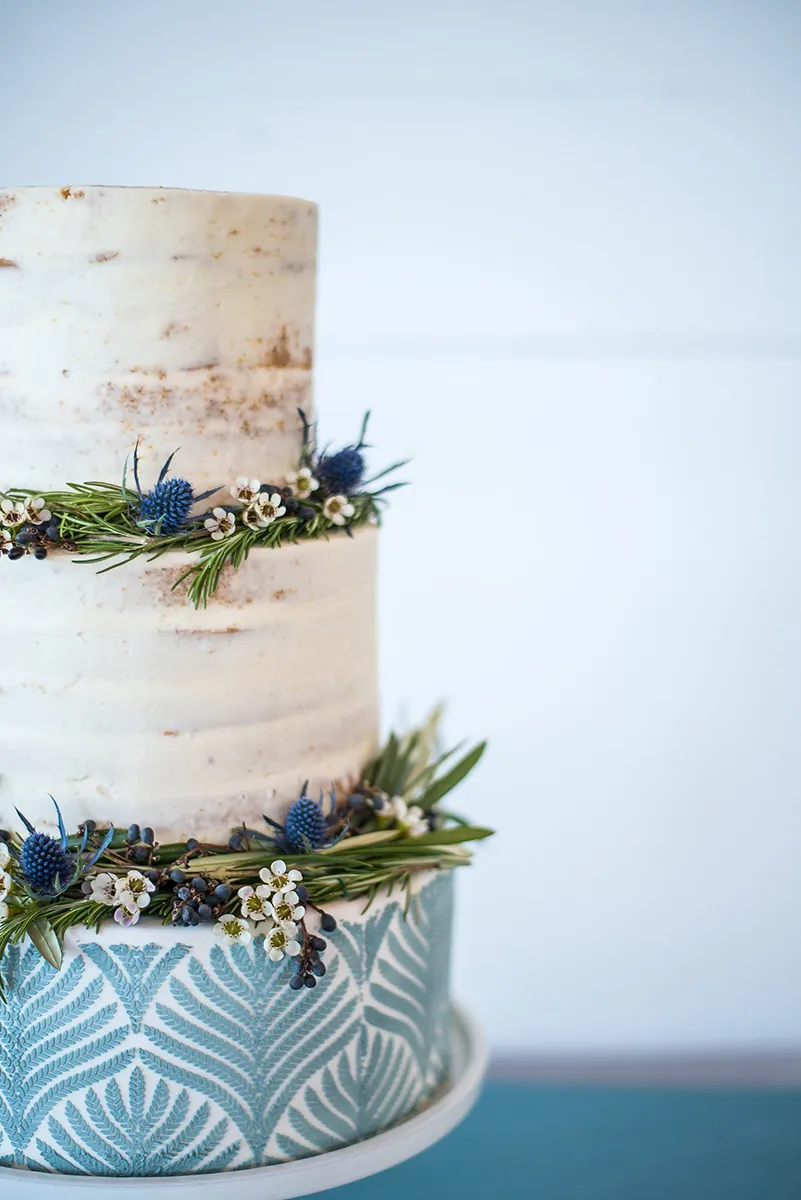 Three tier semi-naked stenciled wedding cake