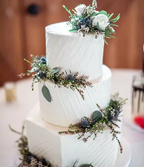 Three tier horizontal homestyle iced wedding cake